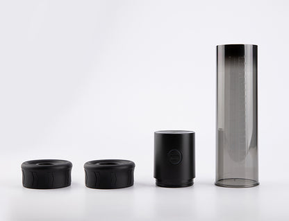 Macho Work 1 vacuum pump with interchangeable silicone rings, pump motor, and transparent measurement tube shown disassembled