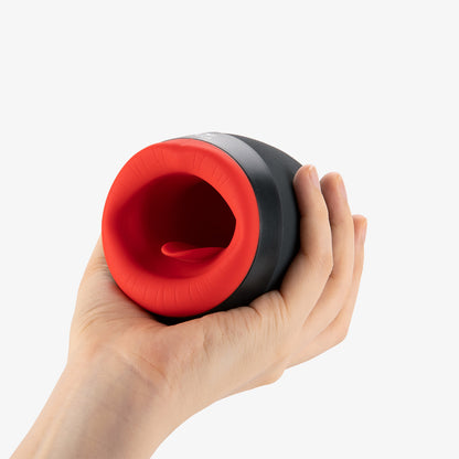 Hand holding the OTOUCH male masturbator, showing the product’s exterior and interior design